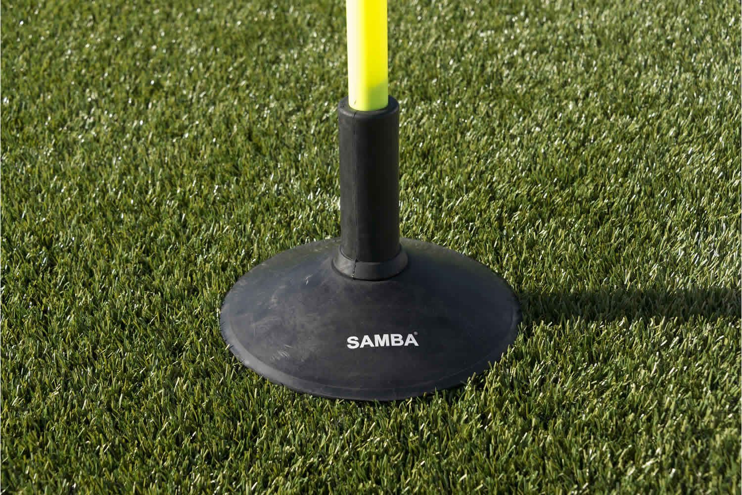 A yellow pole is sitting on top of a black base that says bamba