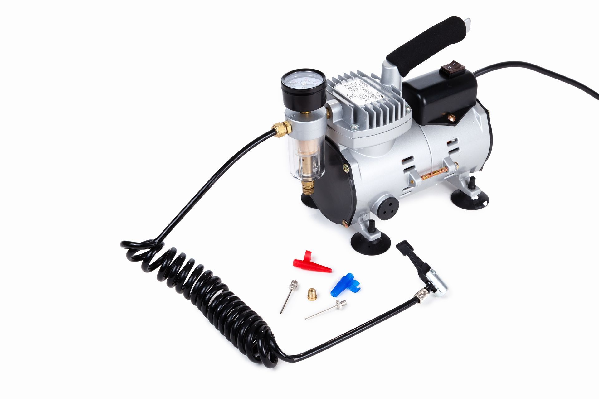 A small air compressor with a hose attached to it