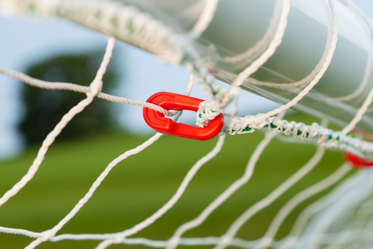 A close up of a soccer net with a red ring on it
