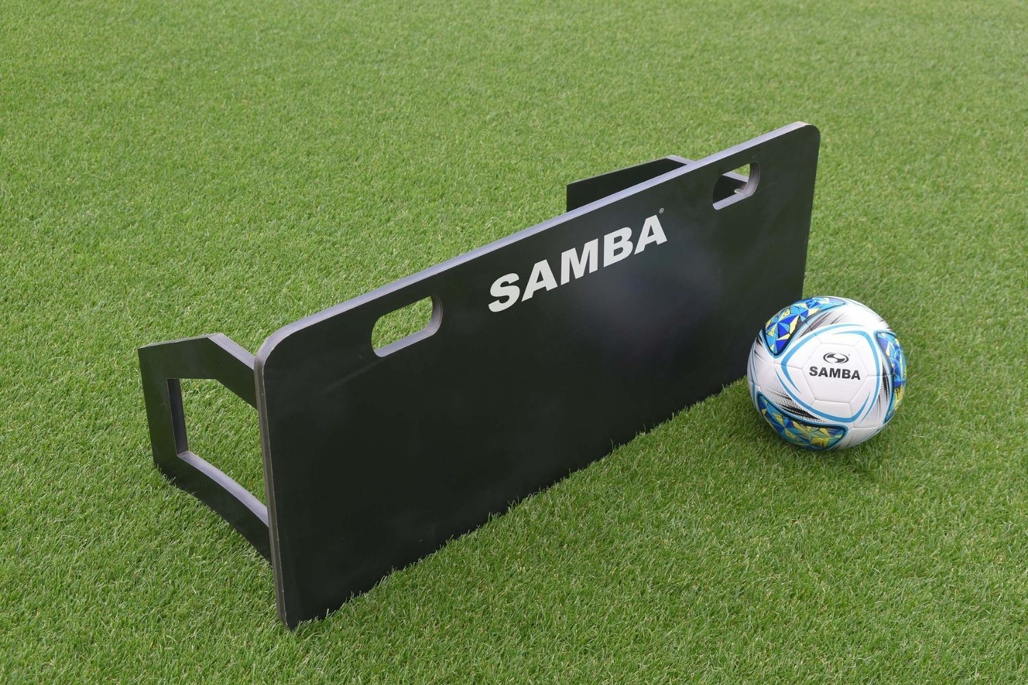 A soccer ball is sitting next to a samba board