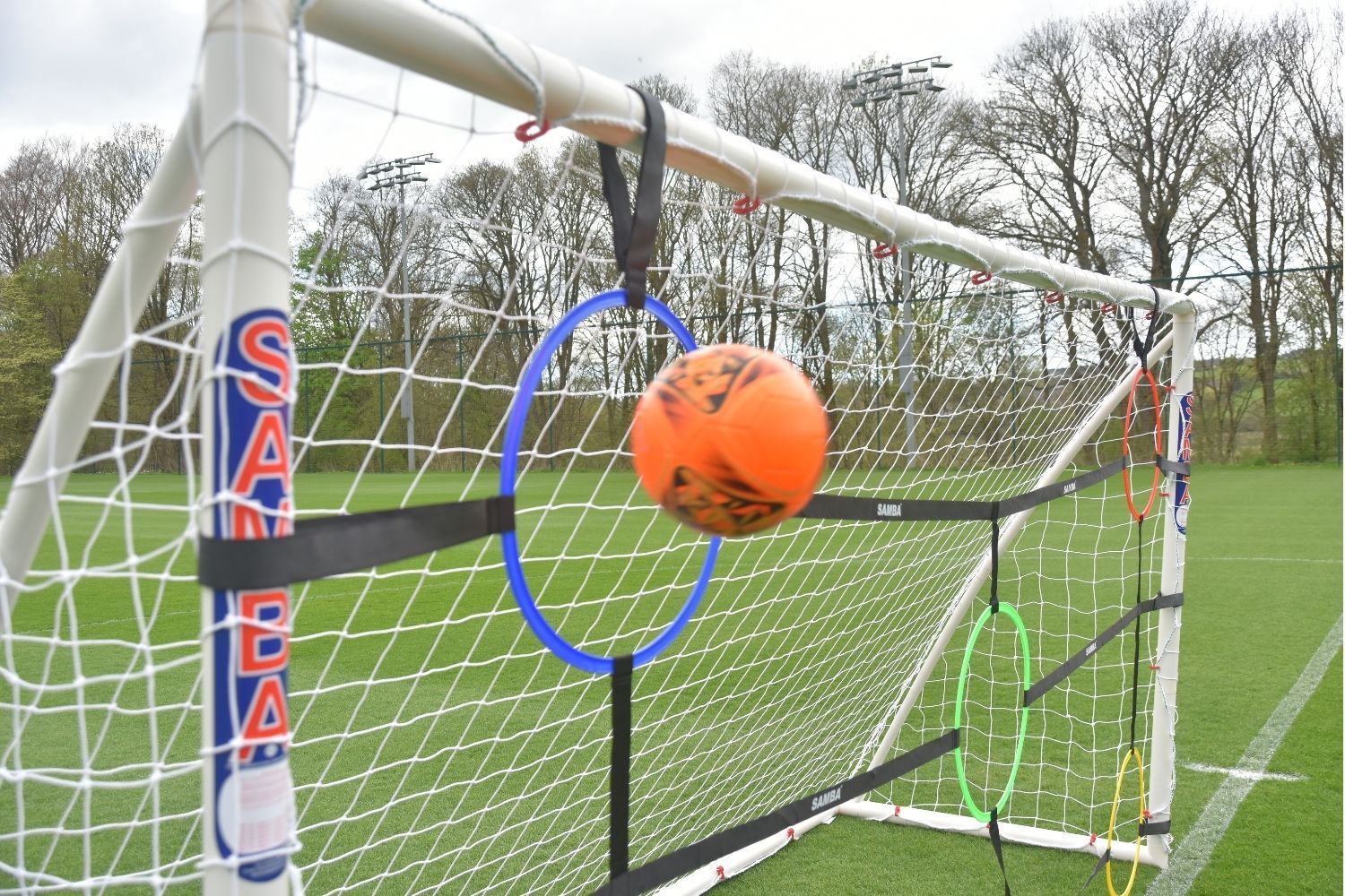 A soccer goal with a bunch of rings attached to it