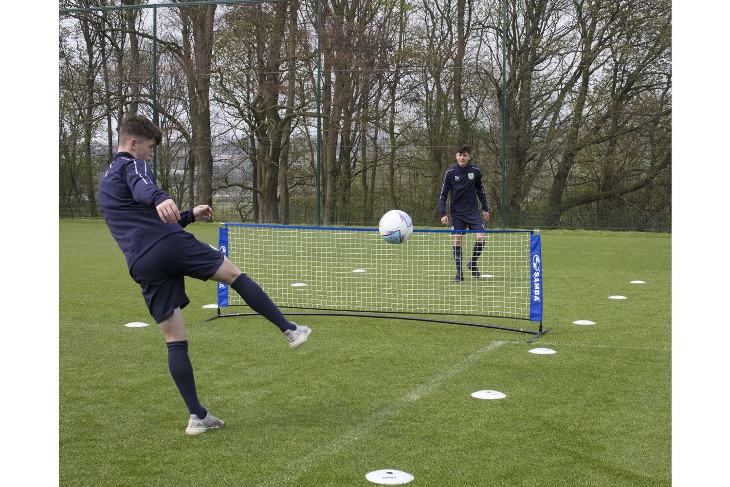 A soccer goal with a blue banner that says ' soccer ' on it