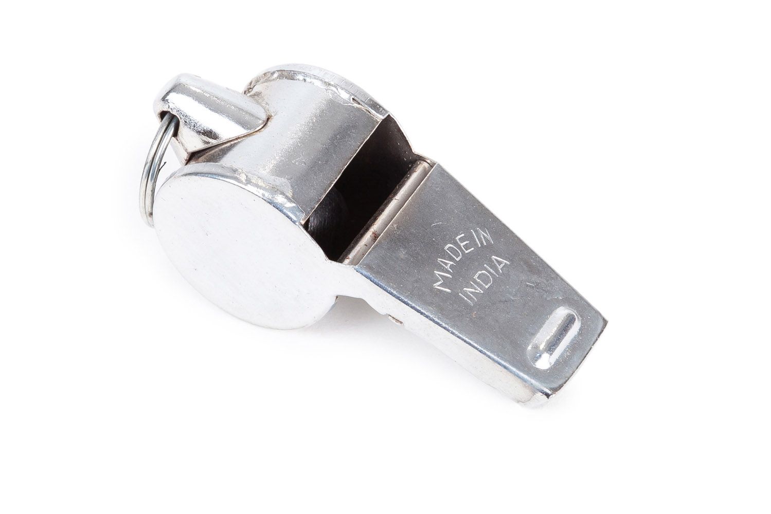 A silver whistle is sitting on a white surface.