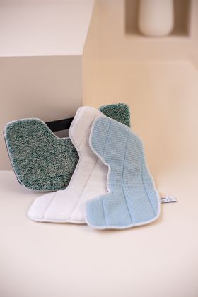 Three cleaning pads are sitting on top of each other on a table.