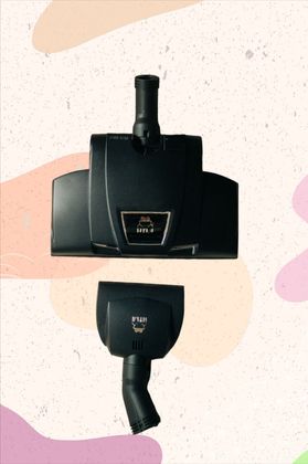 A black vacuum cleaner is sitting on a white surface.