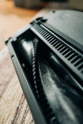 A close up of a vacuum cleaner brush on a carpet.