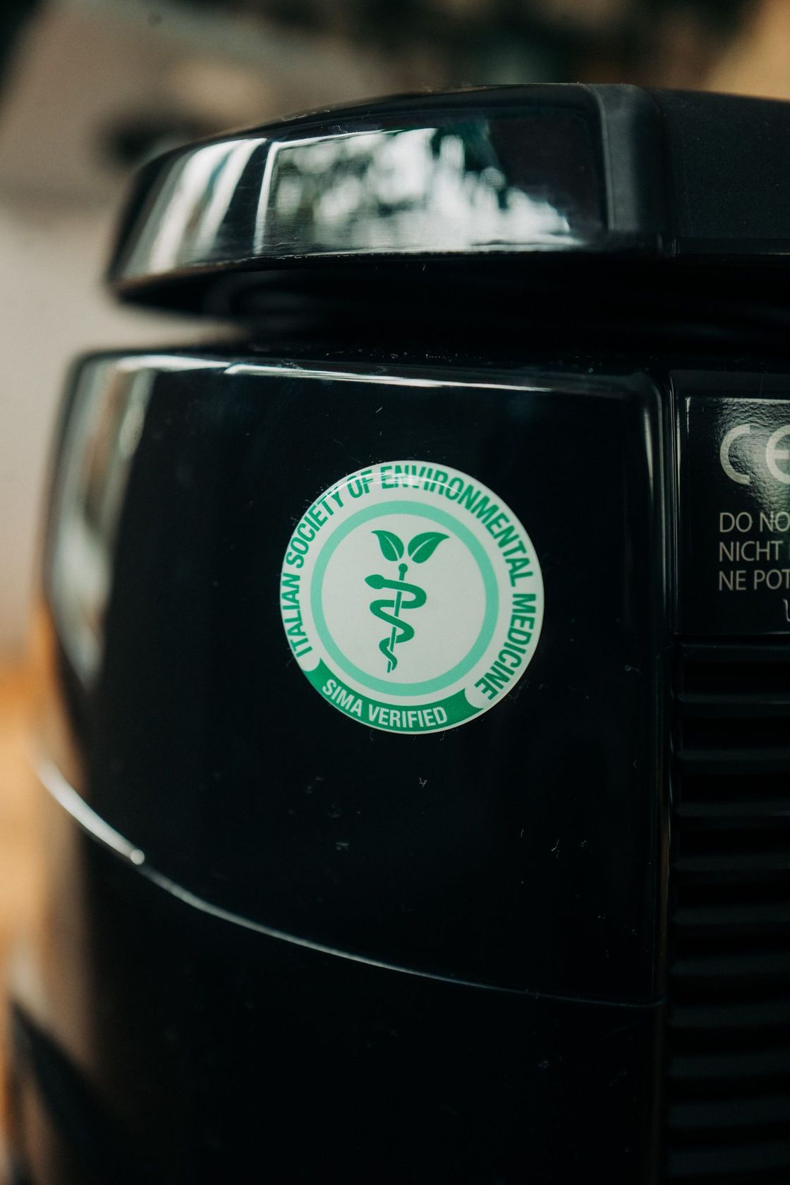 A close up of a vacuum cleaner with a medical symbol on it.
