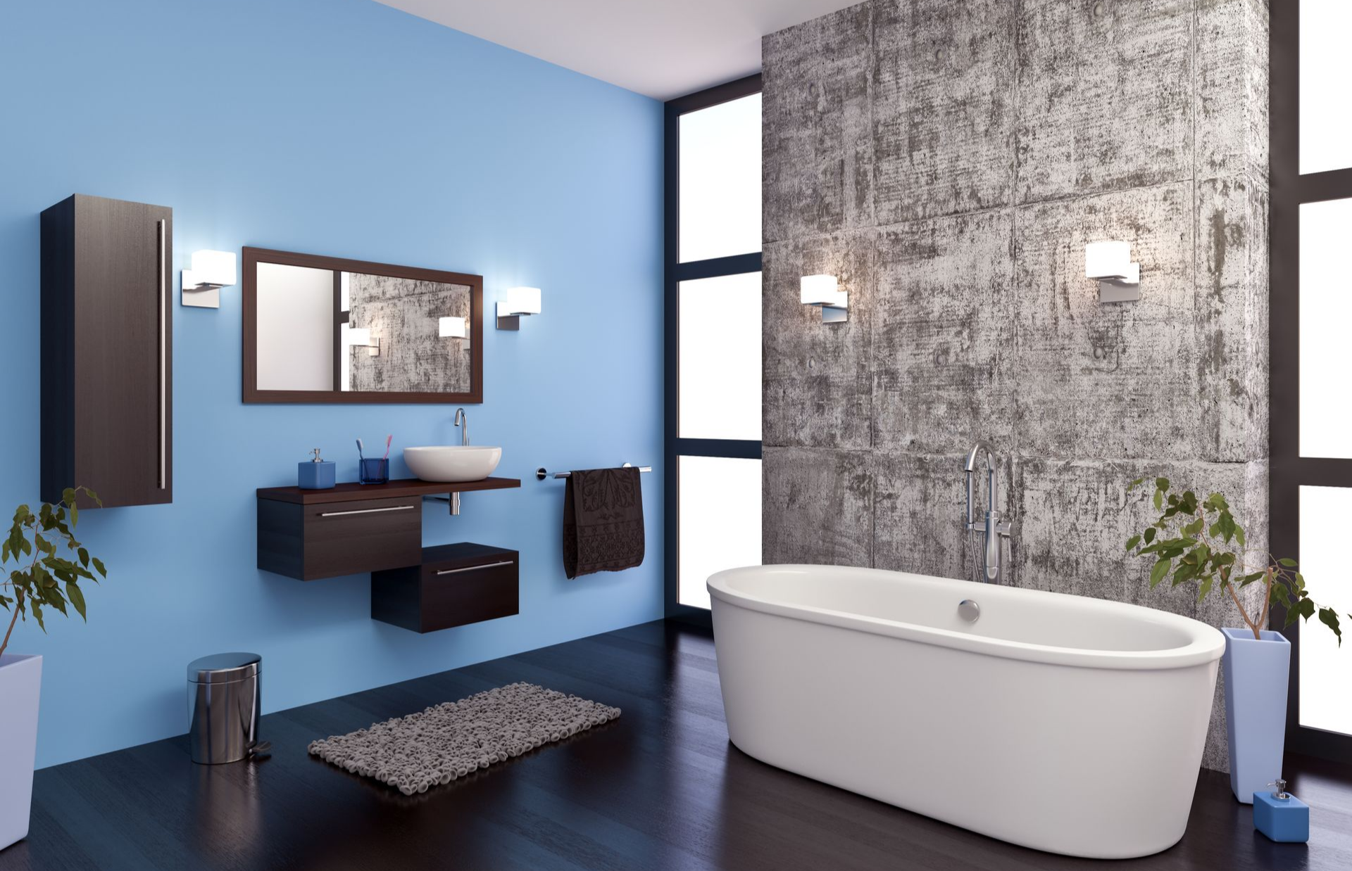 Salle de bains moderne avec murs bleus, meuble lavabo suspendu, baignoire îlot et mur texturé.