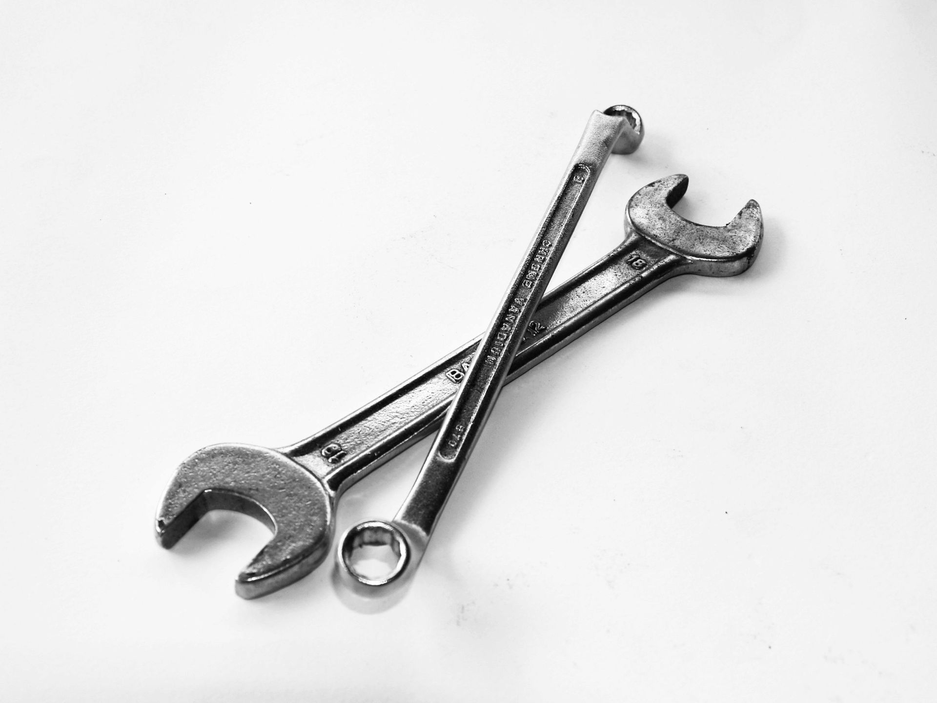 Two wrenches are crossed over each other 
