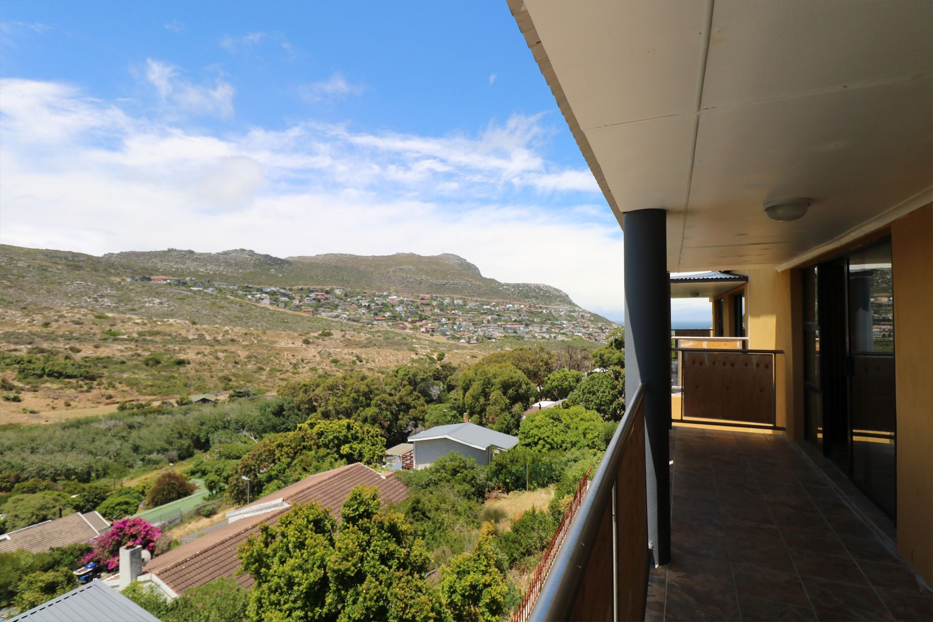 A balcony with a view of a valley and mountains