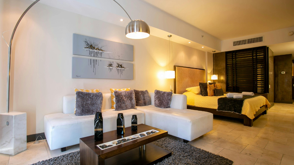 Interior view from a modern restaurant overlooking colourful Muizenberg beach huts and the ocean, symbolising strategic local partnerships.