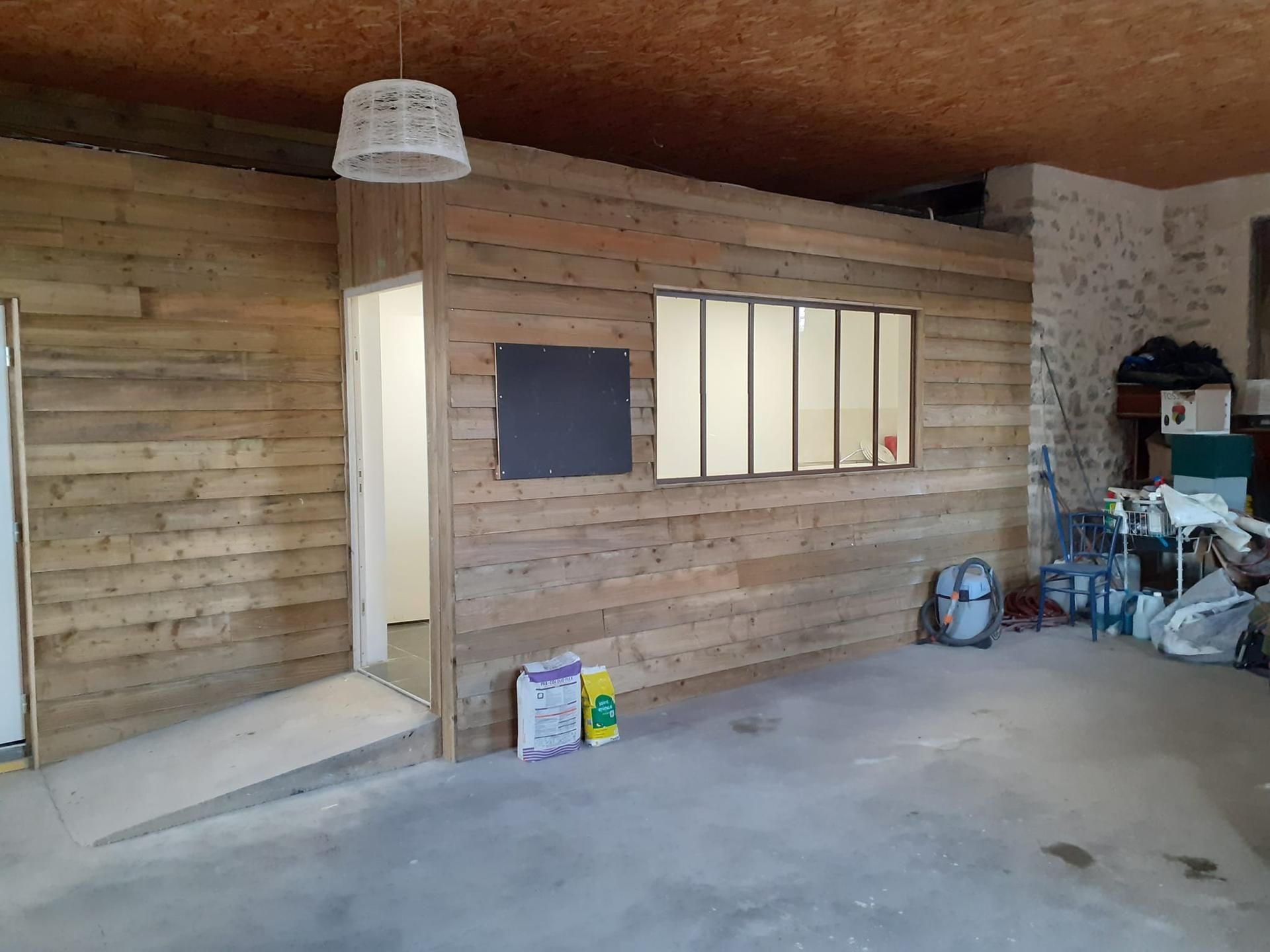 Bardage en bois autour d'une verrière.