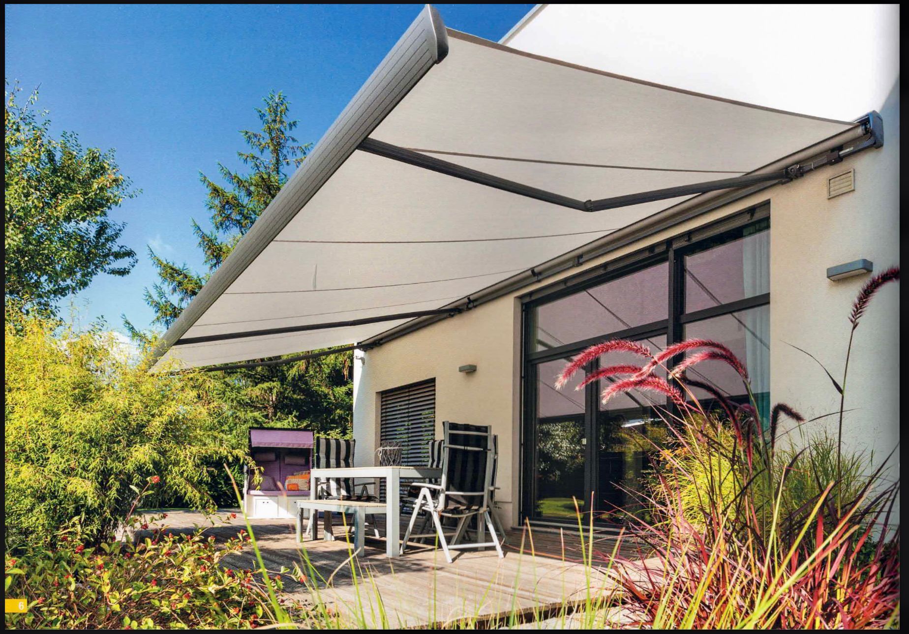 Eine einziehbare weiße Markise spendet Schatten auf einer Terrasse