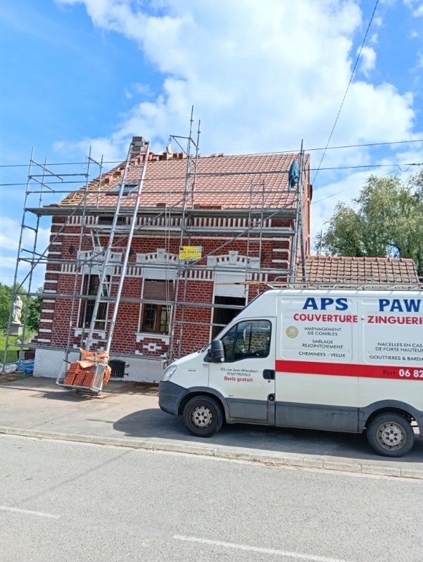 Maison en briques en rénovation avec échafaudages ; camionnette de chantier APS Paw garée devant