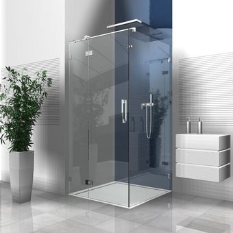 Moderne Duschkabine aus Glas in einem Badezimmer mit Pflanze und schwebendem Waschtisch.