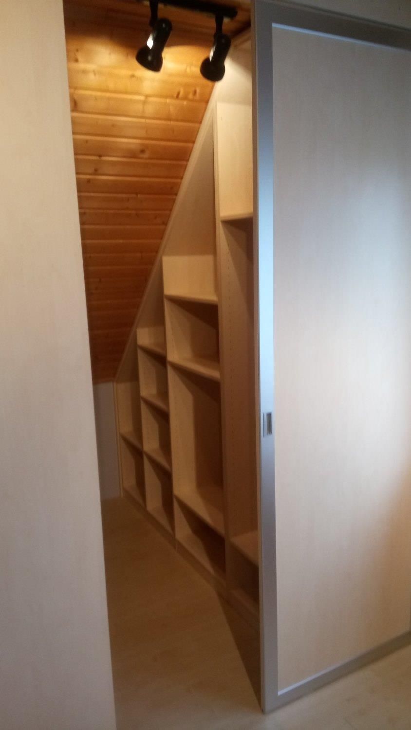 Ein begehbarer Kleiderschrank mit Holzdecke und Regalen