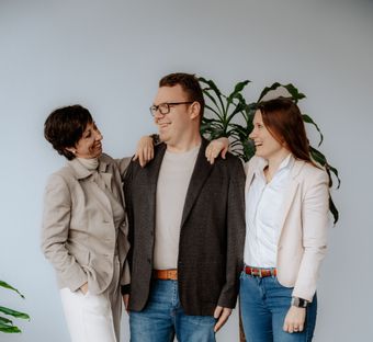 Drei Frauen posieren für ein Foto in einem Raum mit Handtüchern auf der Theke