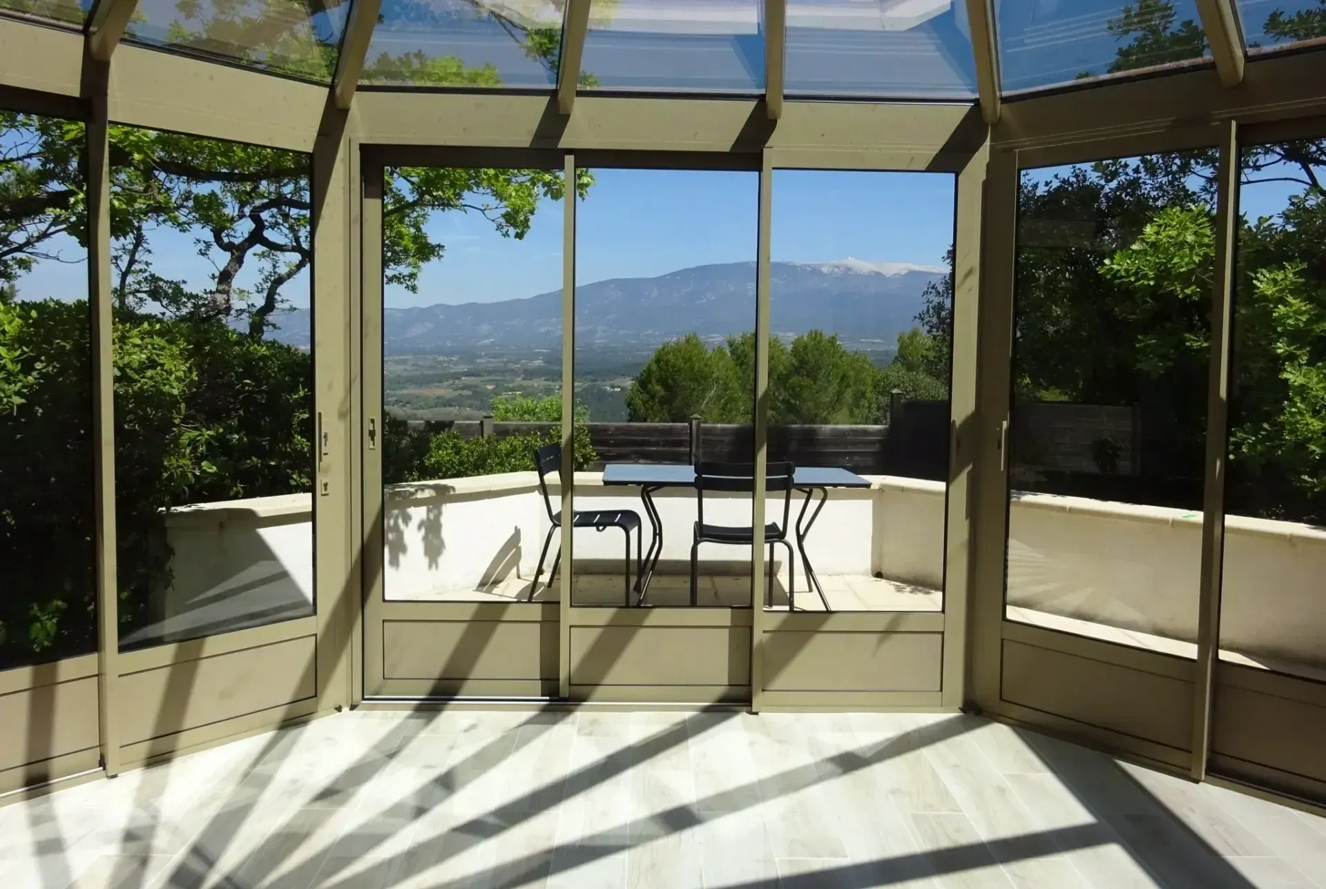 Intérieur d'un salon design avec mur en pierre et fenêtre en aluminium