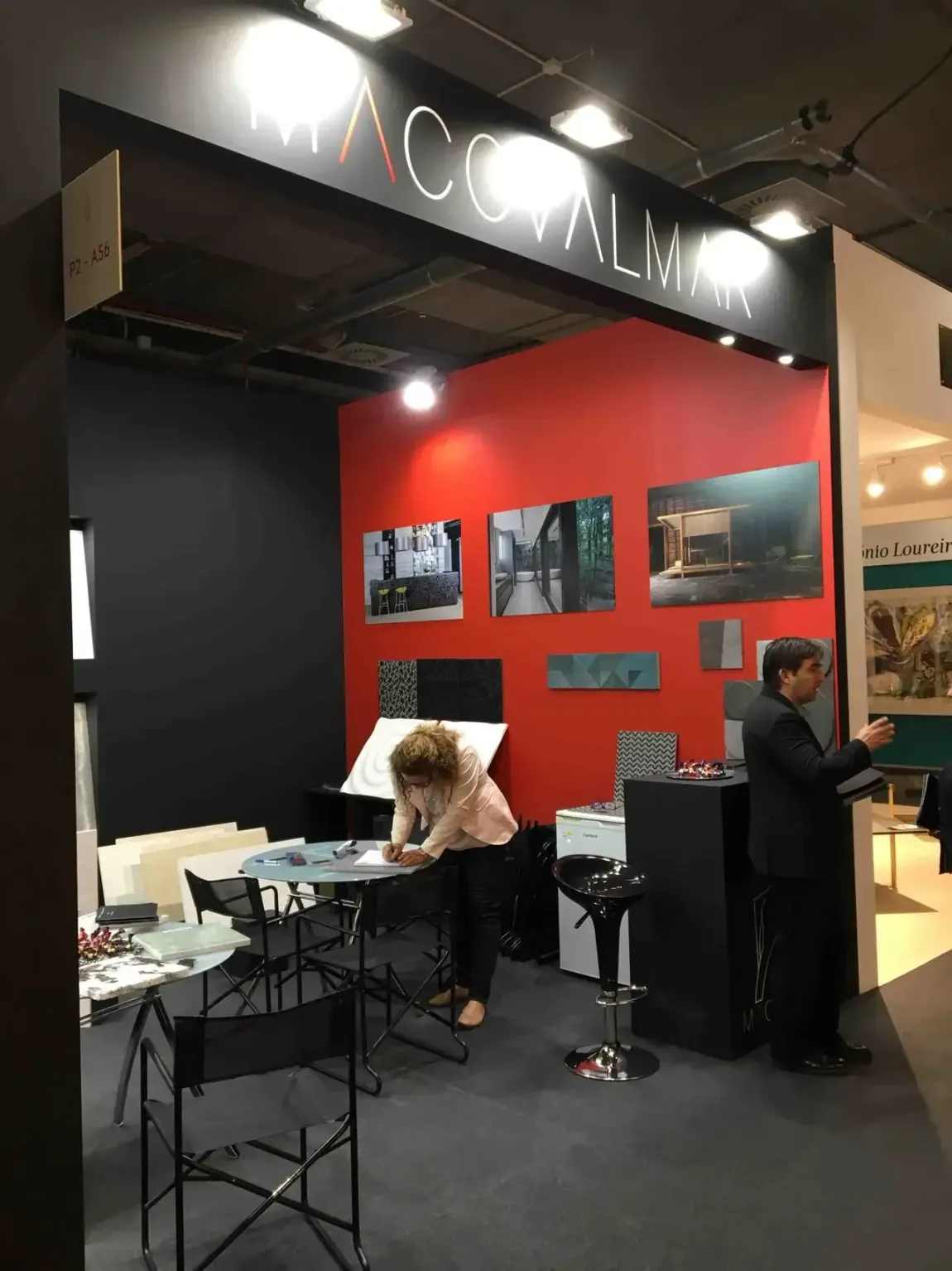 Una mujer se sienta a una mesa en una habitación con un cartel que dice 'accoalmar'.