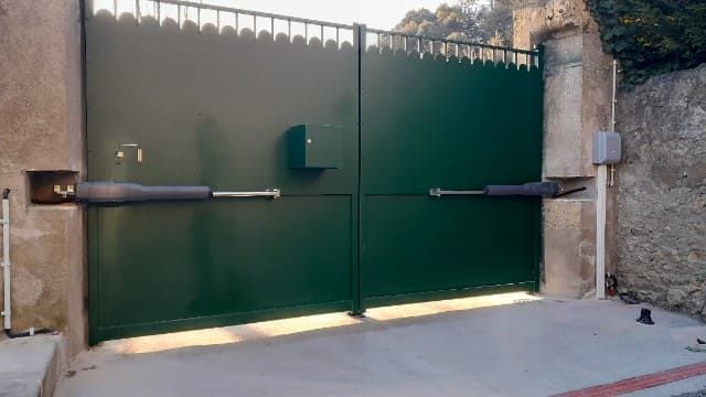 Bras pour l'ouverture d'un portail vert