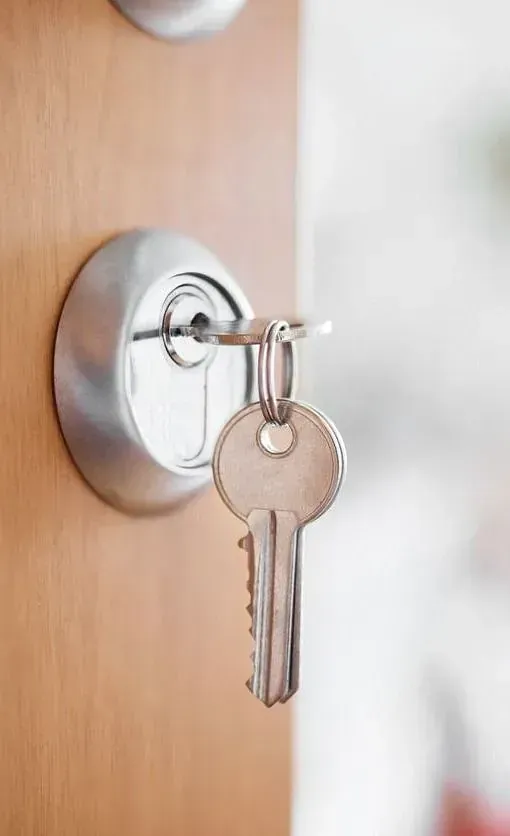 Un primer plano de una llave en la cerradura de una puerta.