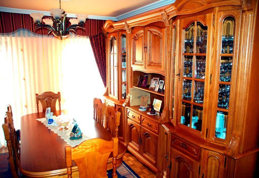 Un comedor con una gran mesa y sillas de madera.