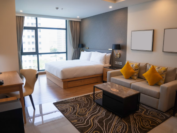 A hotel room with a bed , couch , table and chairs.