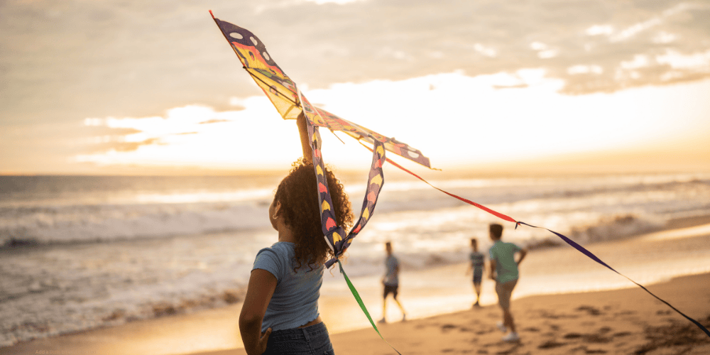 kids flying a kite on Carolina Beach NC