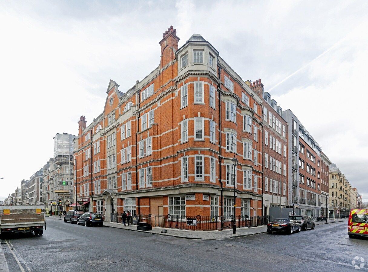 Central London residential building with red brick facade and large windows on a street corner.