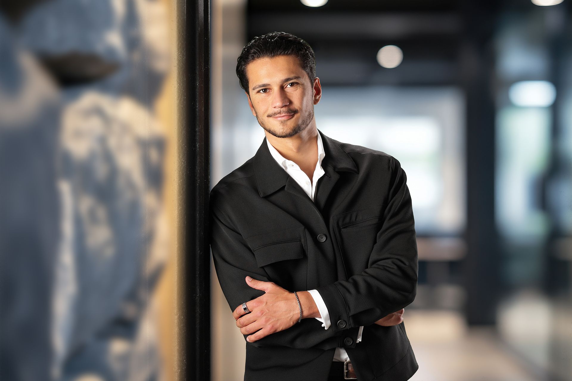 Junger Mann lehnt sich an Wand an