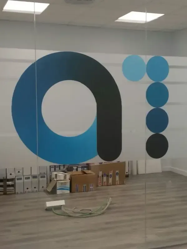 Una pared de cristal con un gran logotipo estilizado de una