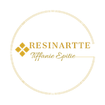 Logotipo de Tiffany Epitie de resina dorada en un marco circular sobre fondo blanco.