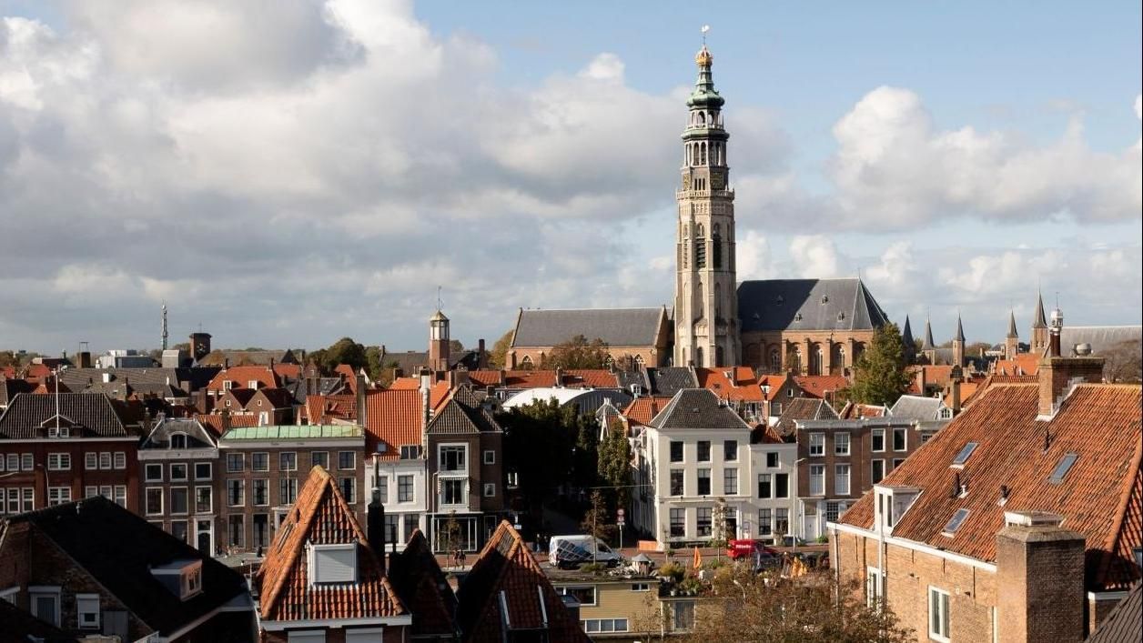 An aerial view of a city with a church in the background