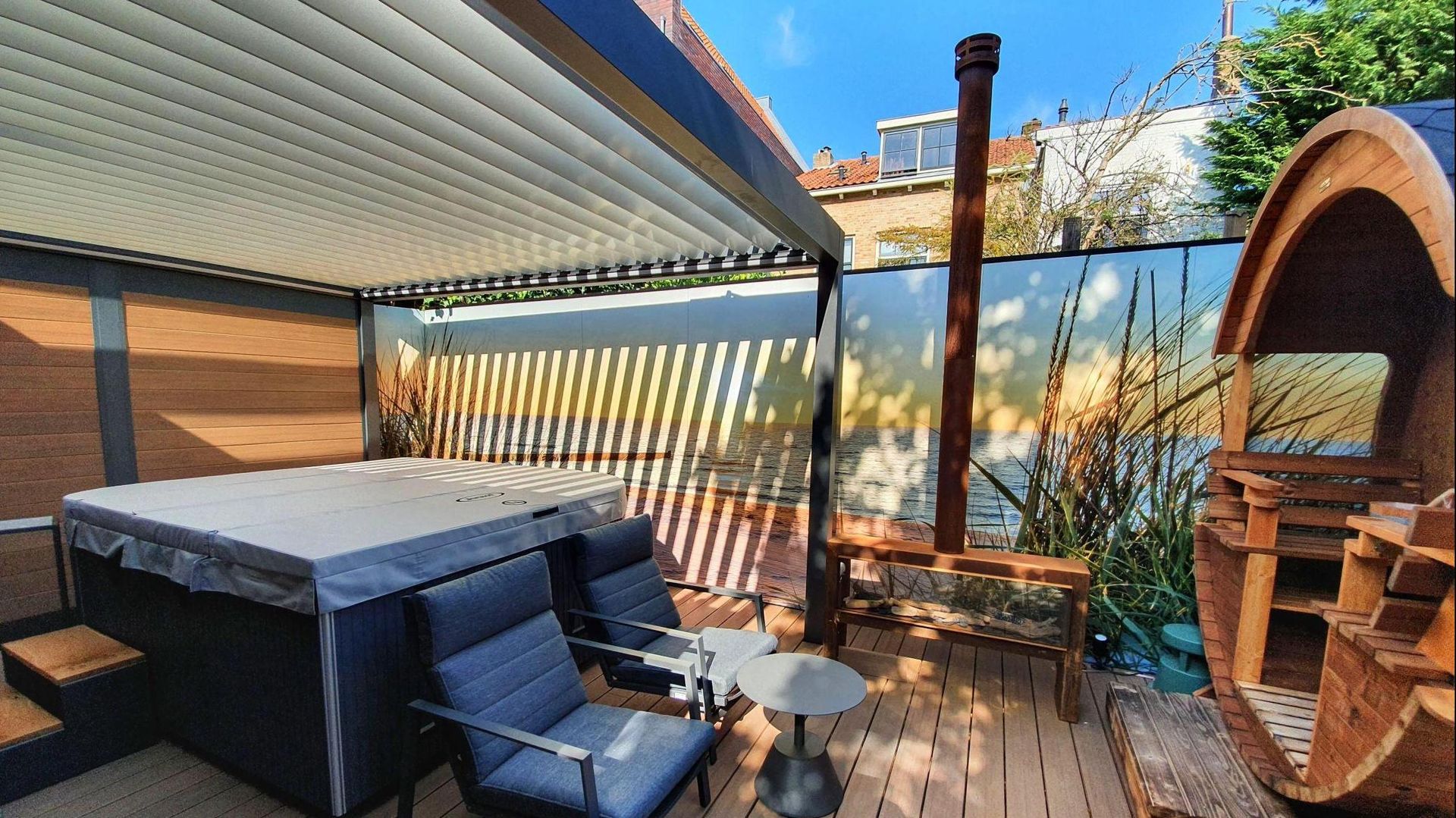 A patio with a hot tub , chairs , tables and a bench.