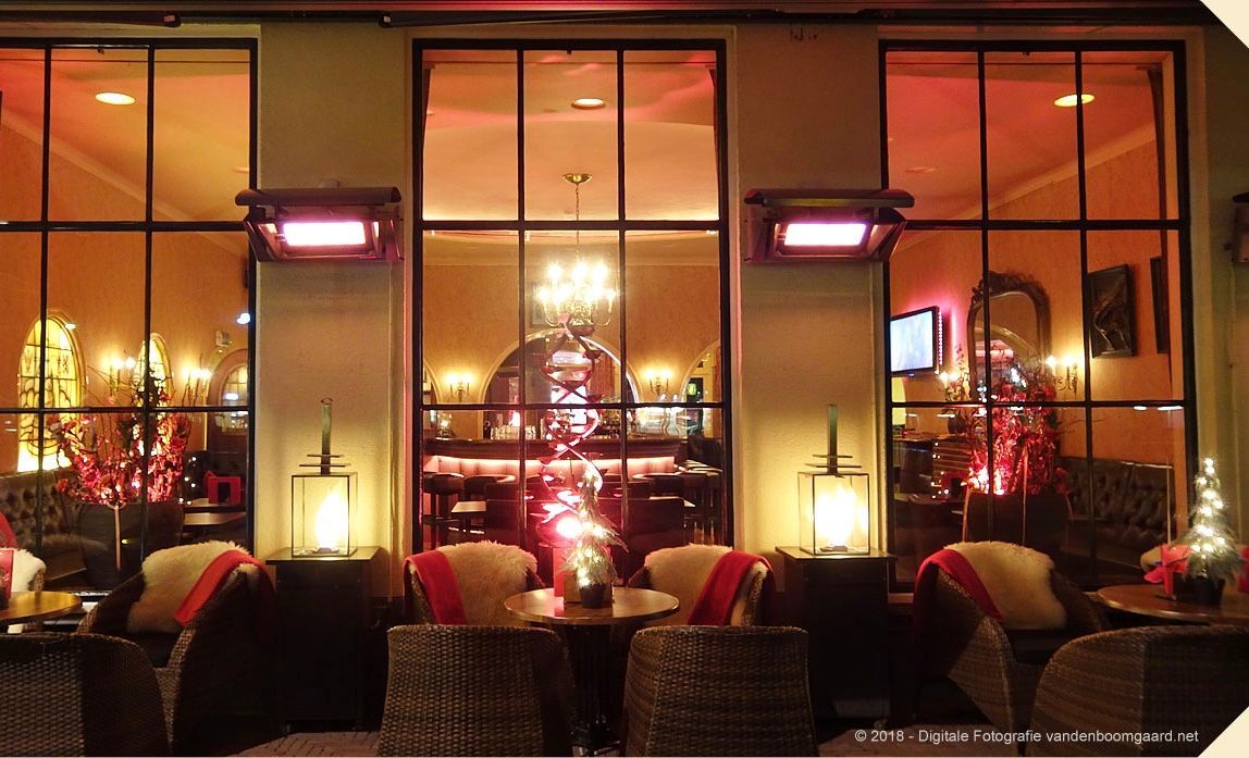 A restaurant with a christmas tree in the window