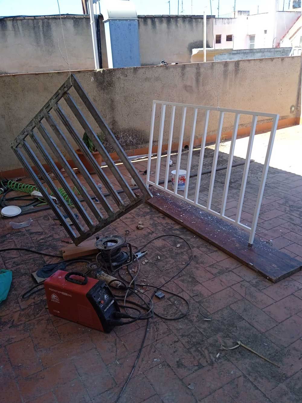 Una máquina de soldar está en el suelo al lado de una barandilla rota.