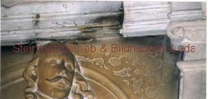 Eine Nahaufnahme einer Löwenkopfstatue an einer Wand.