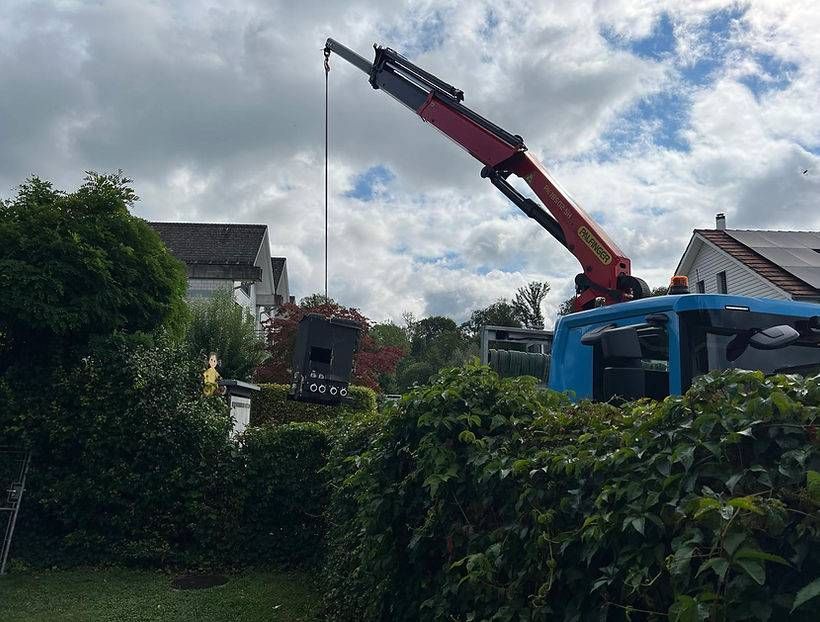 Ein blauer Lastwagen mit einem roten Kran darauf. Foto von der KUROG GmbH