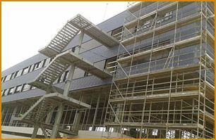 Un edificio en construcción con andamios a su alrededor y una escalera de incendios.