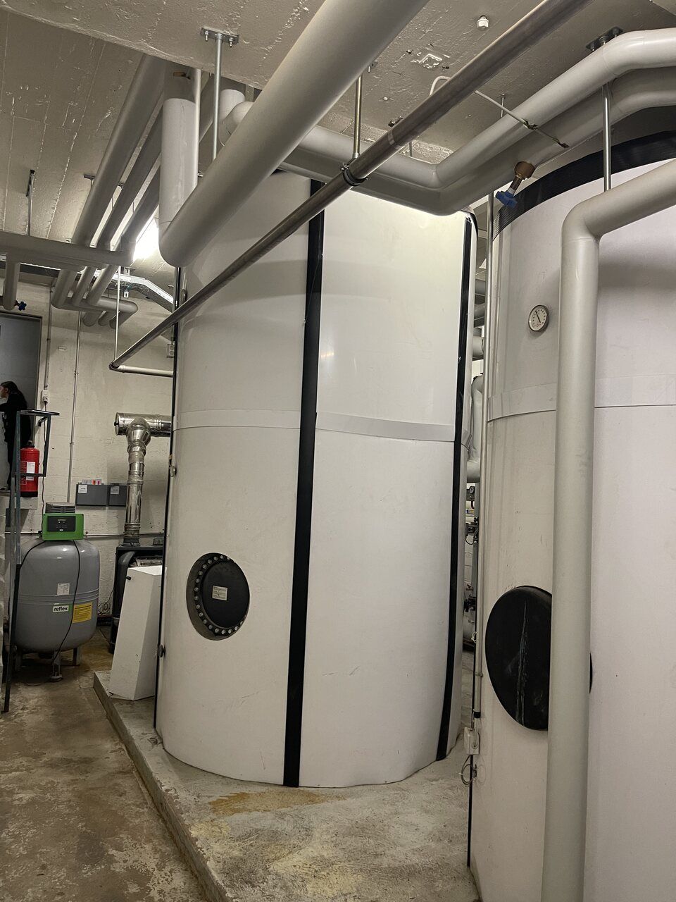 Une pièce avec beaucoup de cylindres et de tuyaux blancs