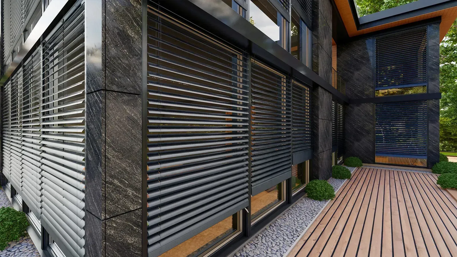 Moderne Gebäudefassade mit dunklem Stein, horizontalen Jalousien über den Fenstern und Holzterrasse.