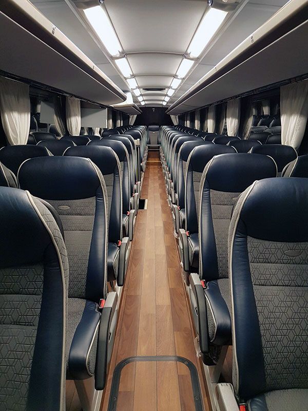 Ein leerer Bus mit blauen Sitzen und einem Holzboden