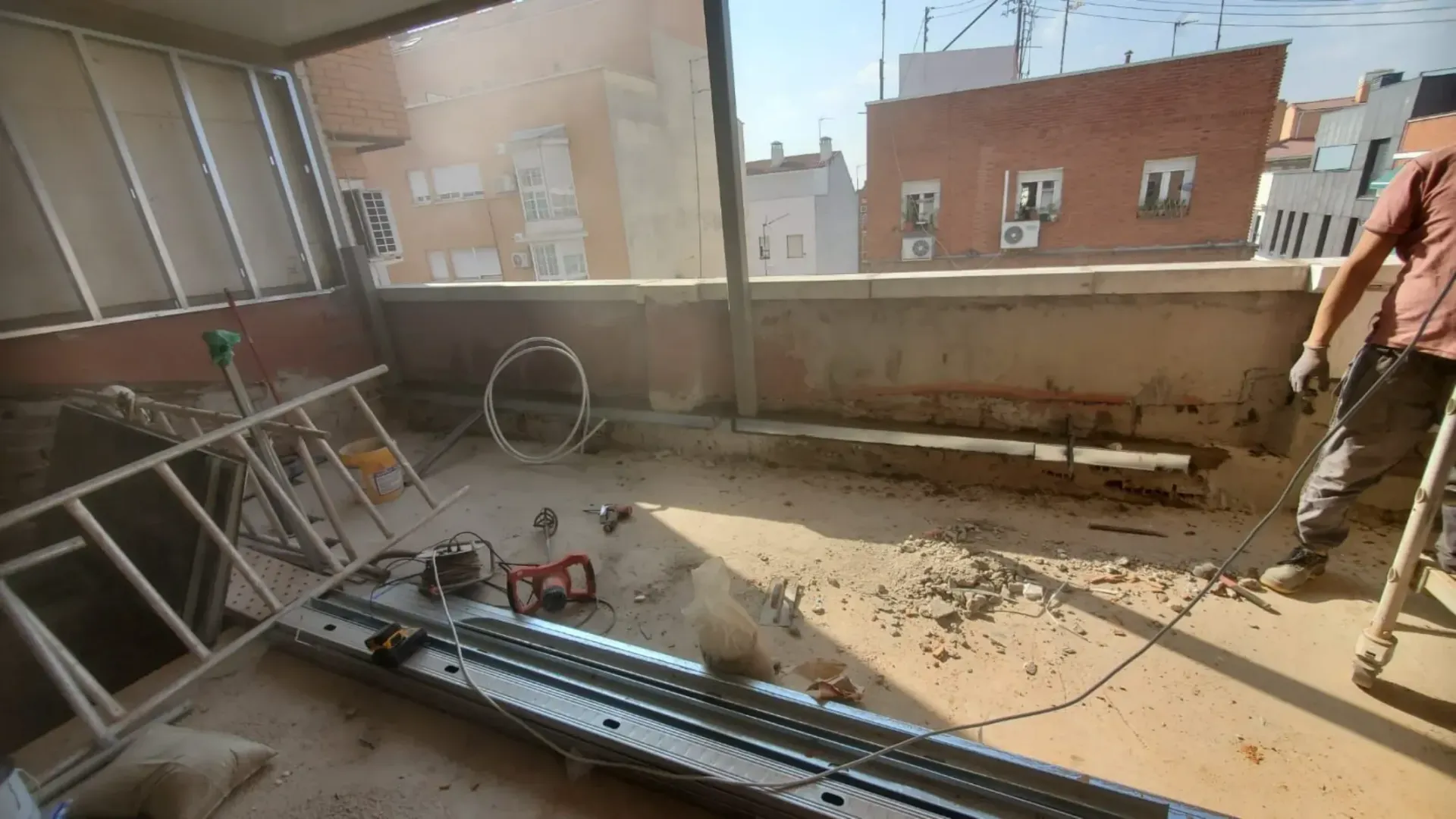 Un hombre está de pie en un balcón con una cadena alrededor de su cintura.