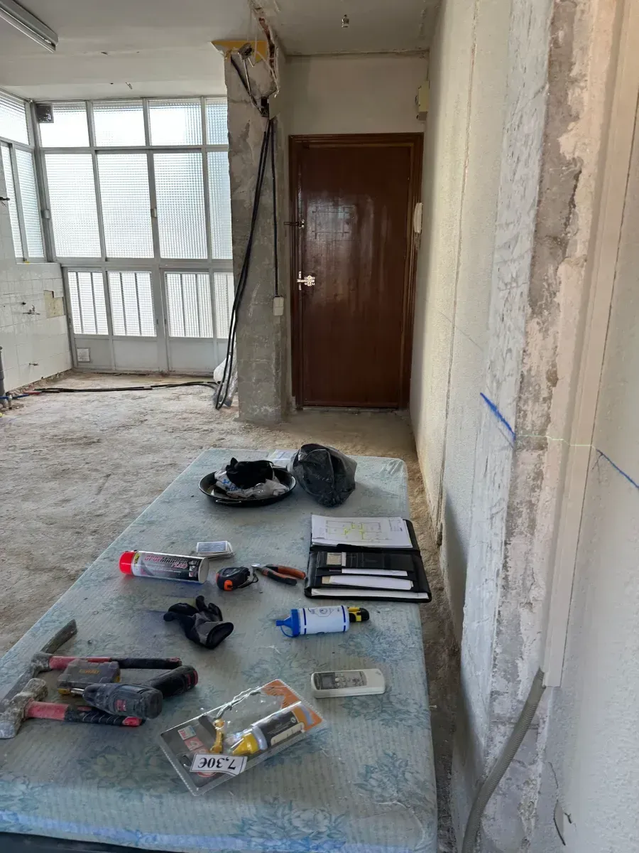 Una mesa con herramientas encima en una habitación con puerta.