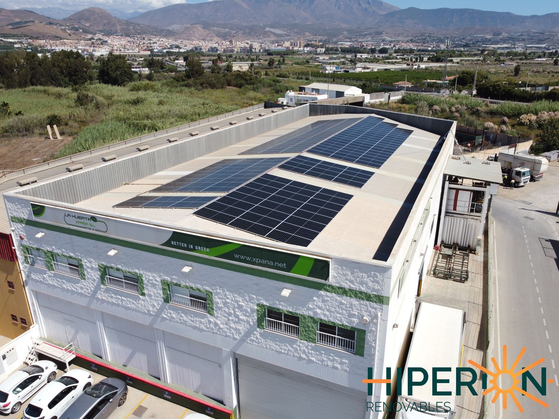 Una vista aérea de un gran edificio con paneles solares en el techo.