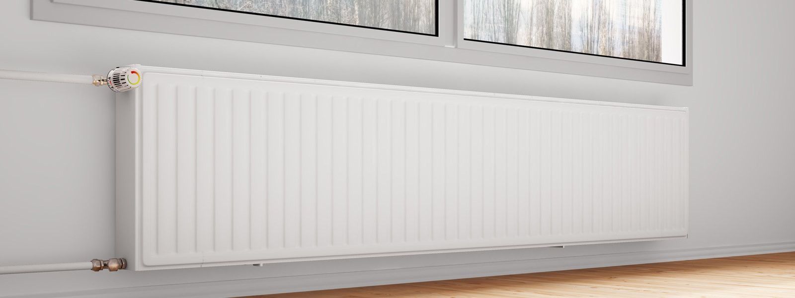 Un radiador blanco está junto a una ventana en una habitación.