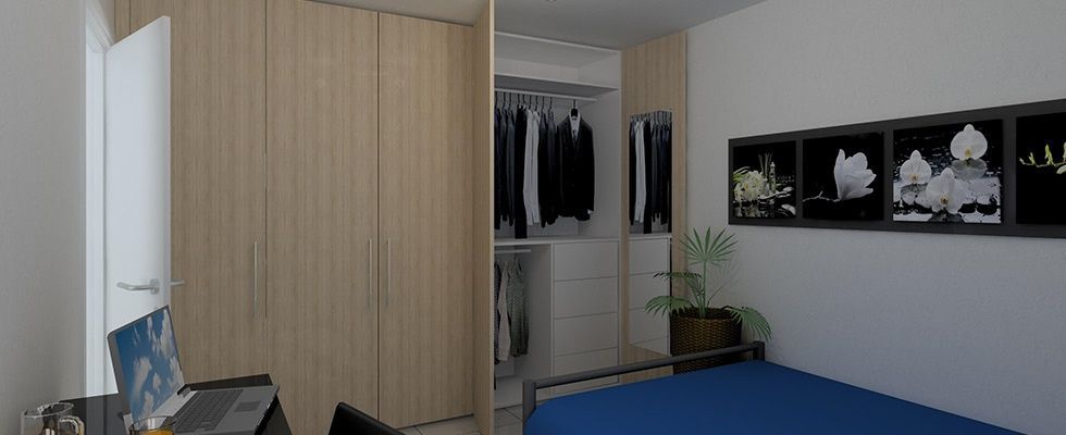 Ein Schlafzimmer mit Bett, Schreibtisch und Schrank.