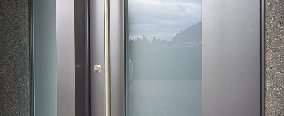 Eine Nahaufnahme einer Edelstahltür mit einem Glasfenster.