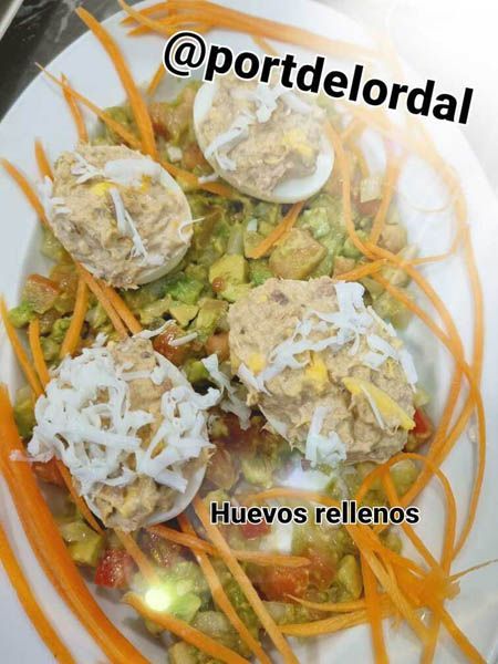 Un primer plano de un plato de comida con una leyenda que dice huevos rellenos.