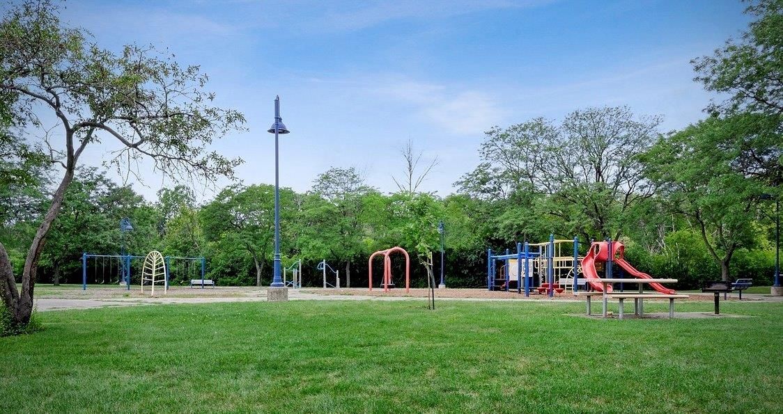 There is a playground in the middle of the park.